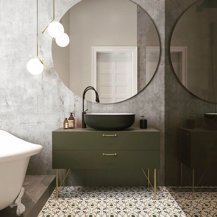grote ronde spiegel boven groen badkamermeubel